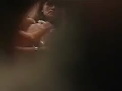 Scene in the changing room of a spy sex film with a sultry wife